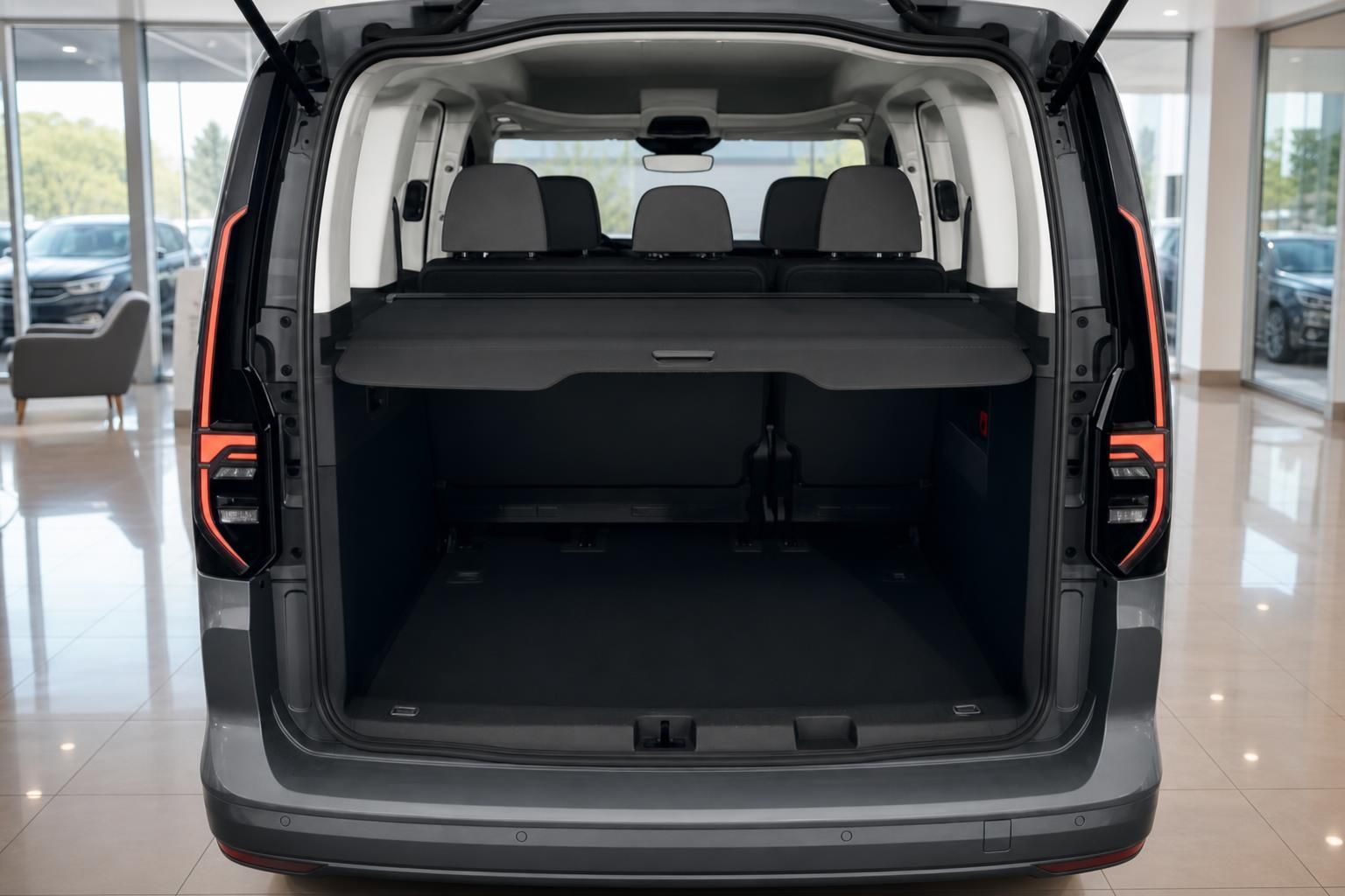 VW Caddy Kofferraum mit geoeffneter Heckklappe und Laderaumabdeckung