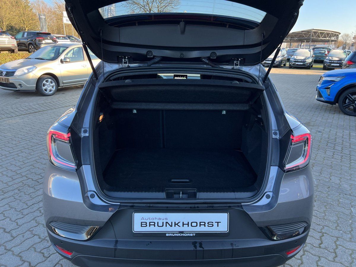 Grauer Kompaktwagen mit geöffnetem Kofferraum im Autohaus Brunkhorst Showroom