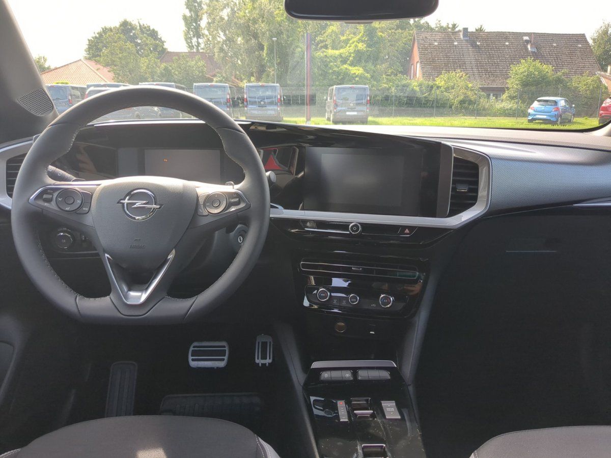 Opel Innenraum mit Lenkrad, digitalem Cockpit und Infotainment-Display im Autohaus