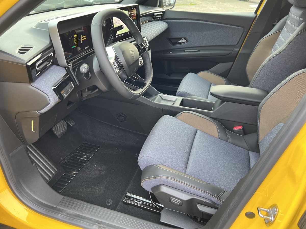 Renault Clio Innenraum mit digitalem Cockpit, Stoffsitzen und modernem Infotainment in gelber Karosserie