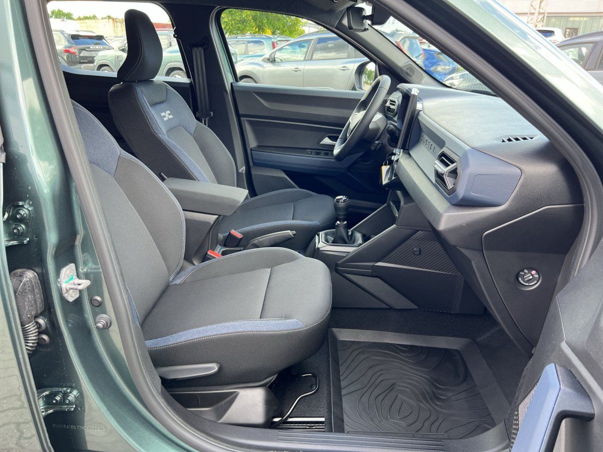 Dacia Duster Innenraum Fahrerseite mit schwarzen Stoftsitzen und Schaltgetriebe