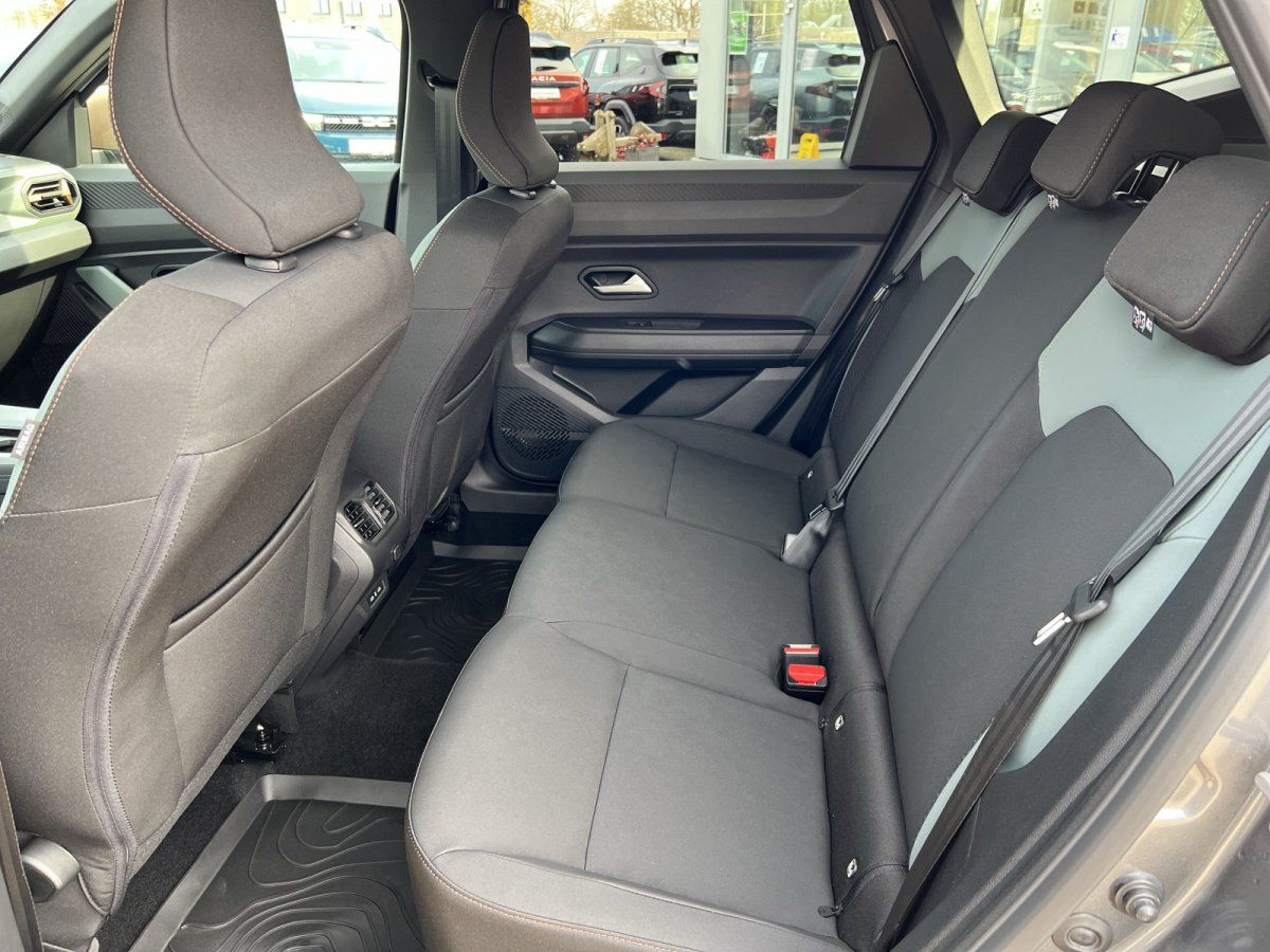 Rücksitzbank eines Fahrzeugs mit grauen Polstern und Sicherheitsgurten