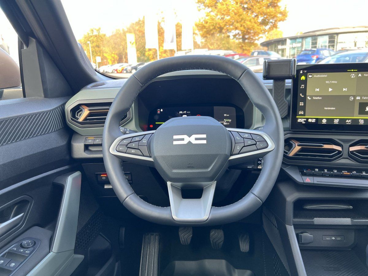 Dacia Innenraum mit Lenkrad, digitalem Cockpit und zentralem Touchscreen-Infotainmentsystem