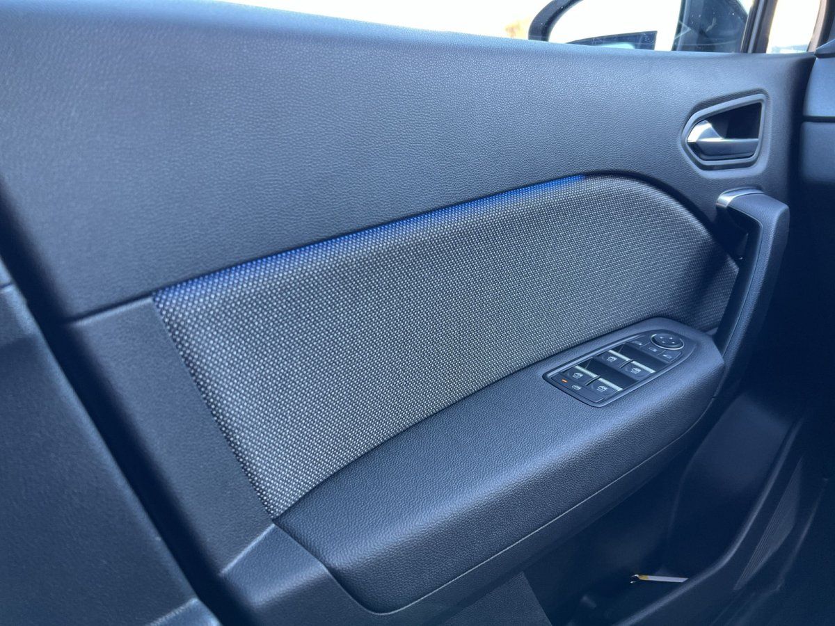 Fahrzeuginnenraum Fahrertür mit Fensterheber-Schaltern und blauer Ambientebeleuchtung im Autohaus