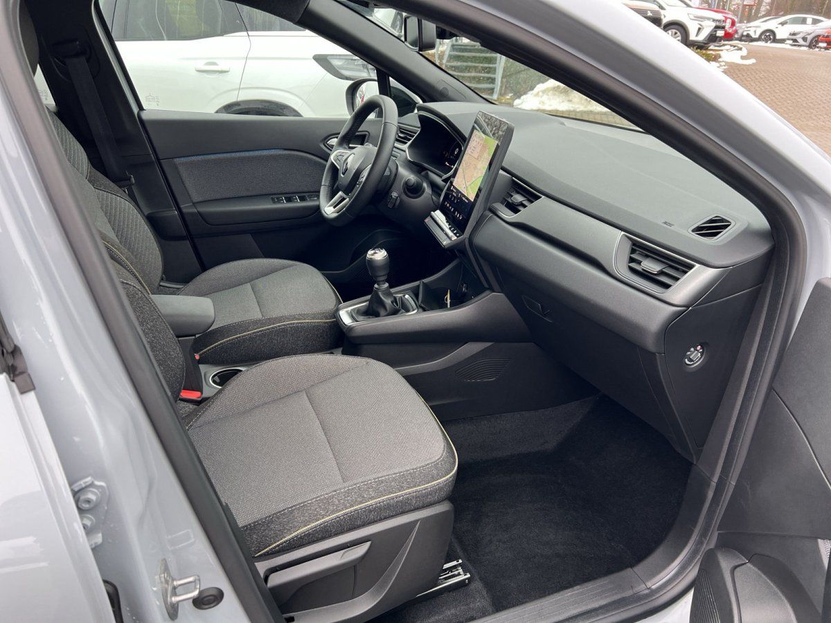 Renault Innenraum mit modernem Infotainment-Display, grauen Stoffsitzen und digitalem Cockpit