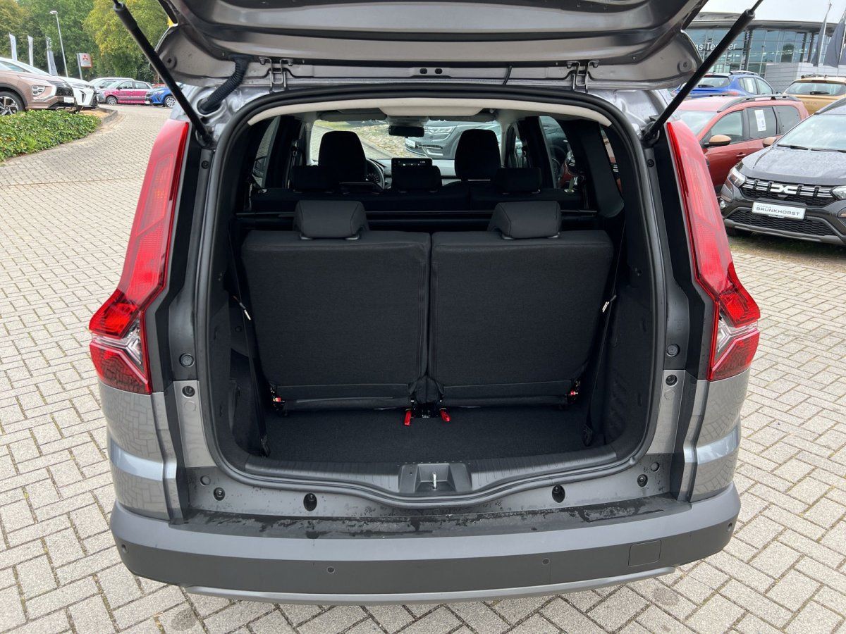 Grauer Dacia Lodgy Kofferraum offen mit umklappbaren Rücksitzen im Autohaus