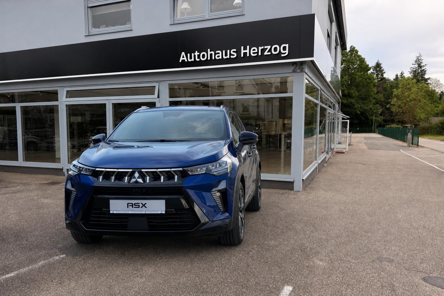 Mitsubishi ASX blau Frontansicht nah vor Glasfront
