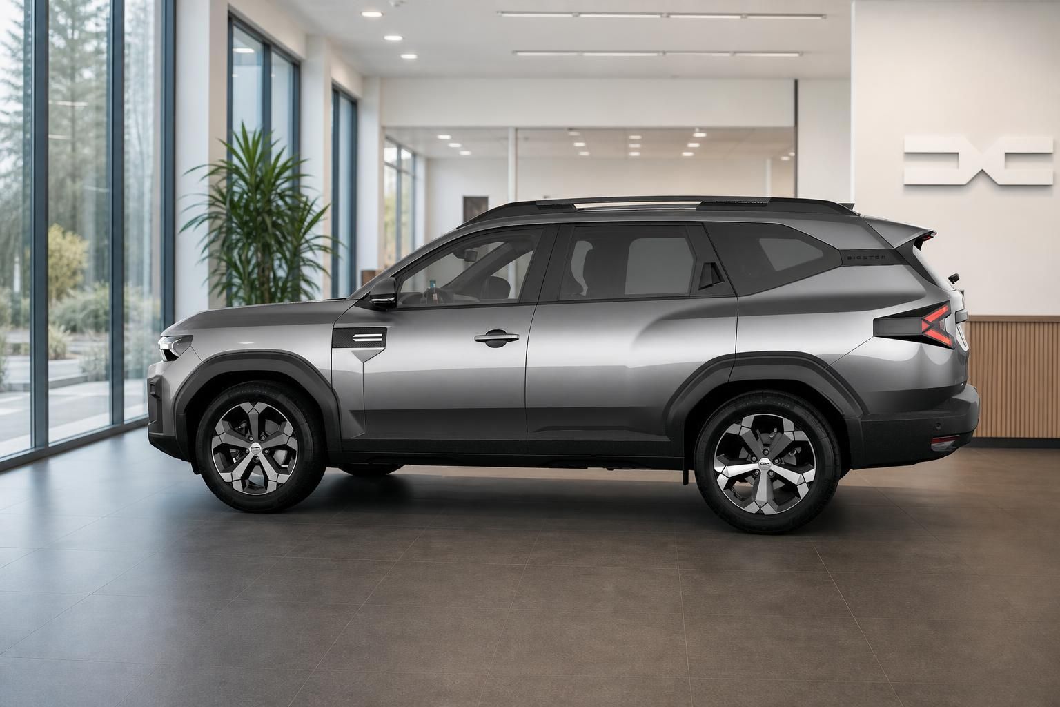 Dacia Bigster grau Seitenansicht im modernen Autohaus