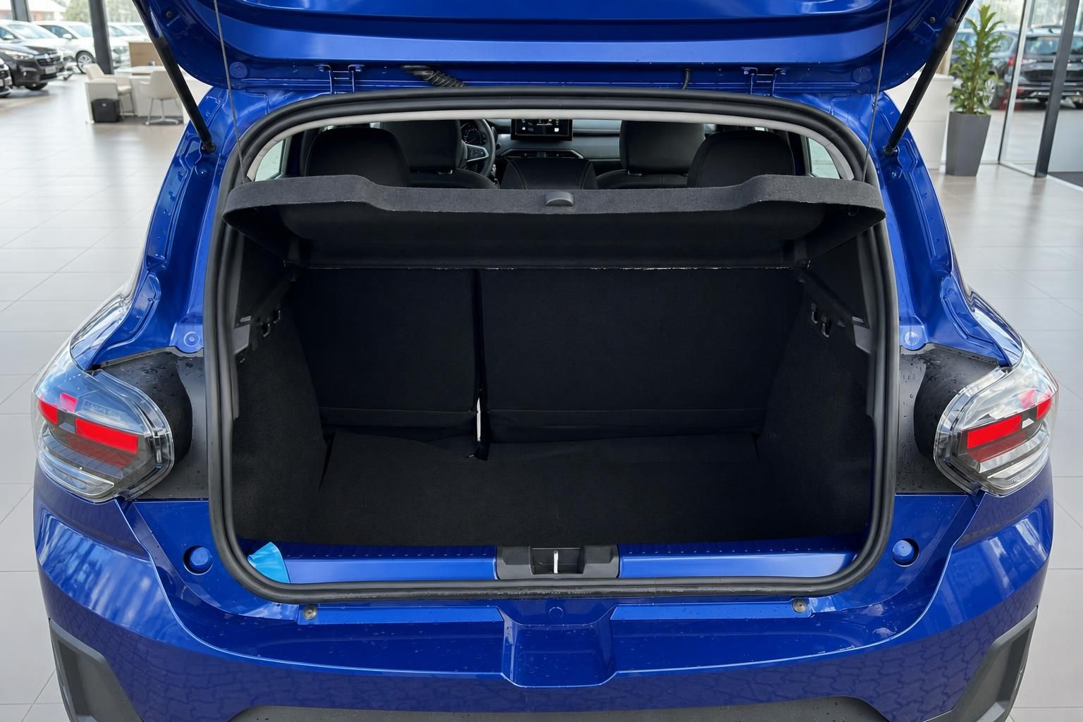Offener Kofferraum des blauen Dacia Sandero SUV mit schwarzer Innenausstattung