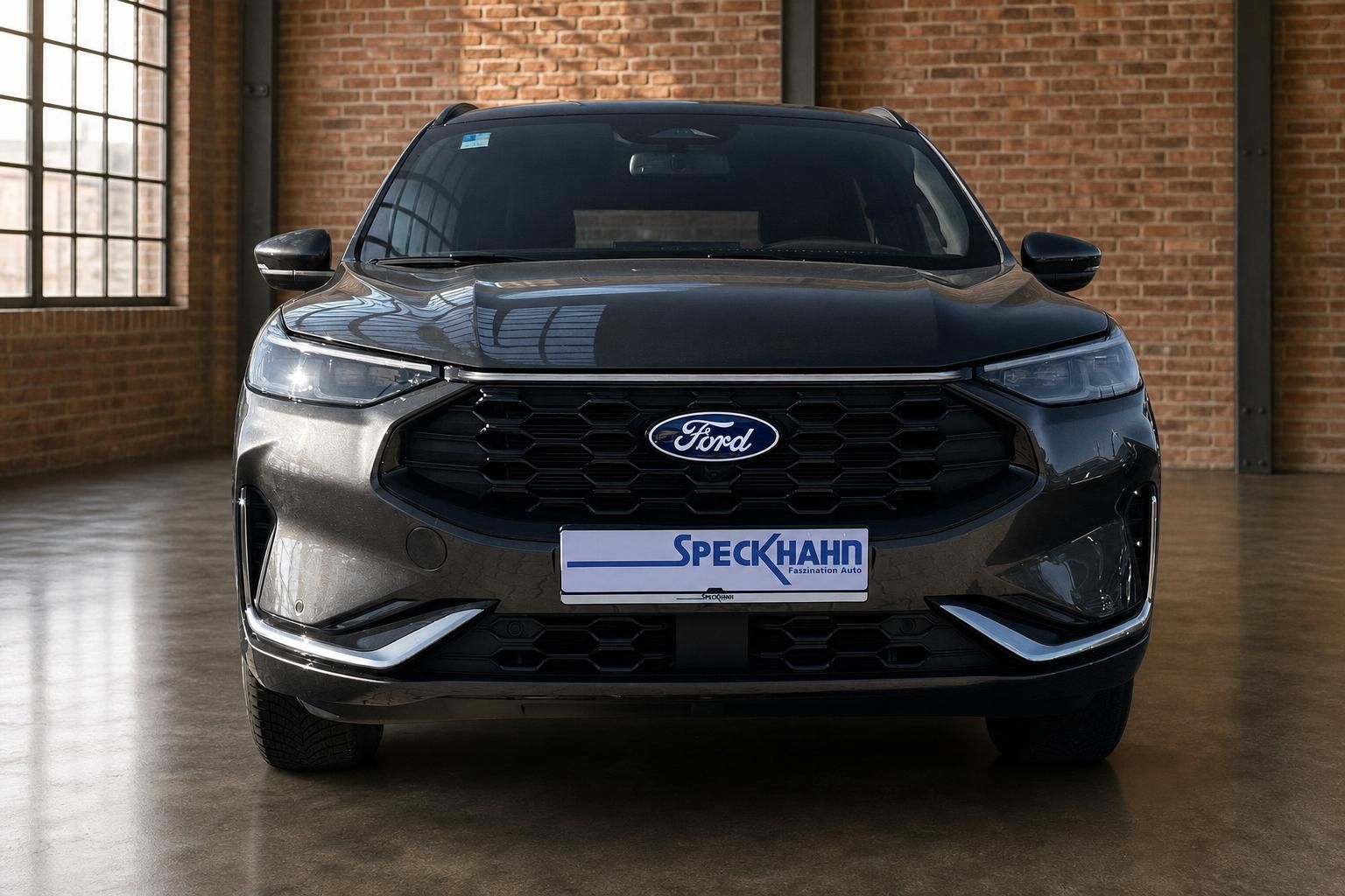 Ford Kuga SUV grau Frontansicht mit Speckhahn Händlerkennzeichen in Industriehalle