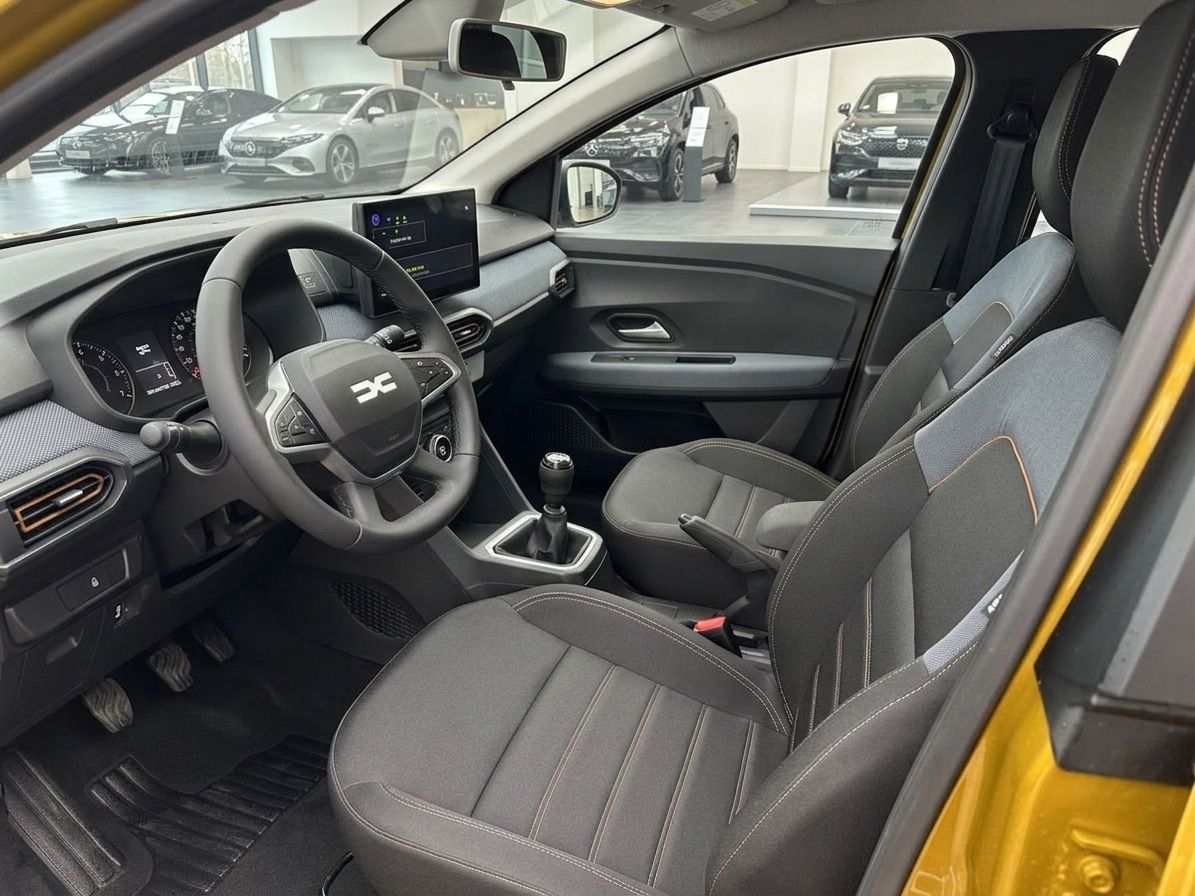 Dacia Innenraum mit grauem Interieur, Lenkrad, Sitze und modernem Display