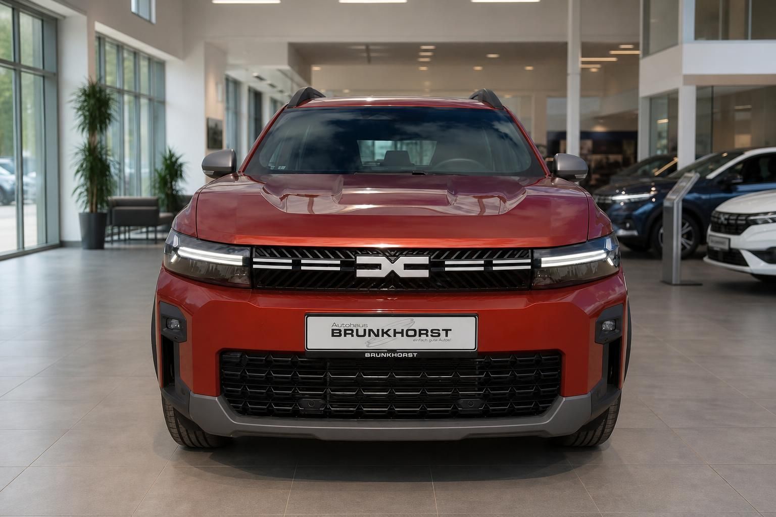 Rote Dacia Frontansicht im Autohaus Brunkhorst - moderne SUV-Optik mit charakteristischem Kühlergrill