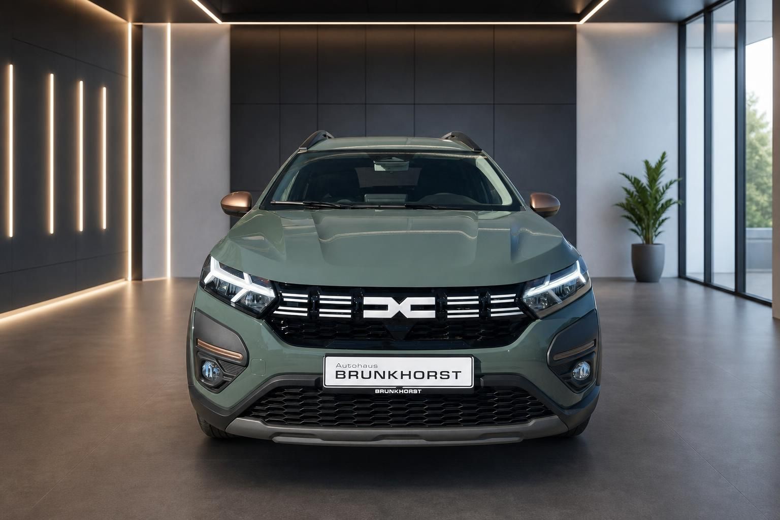 Dacia Jogger in gruen - Frontansicht im modernen Autohaus Showroom