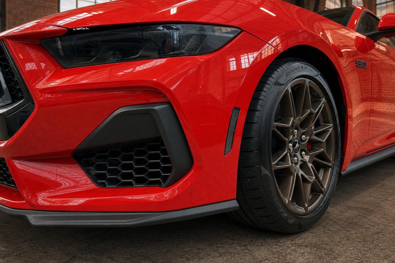 Seitliche Detailansicht Frontstossstange und Felge des roten Ford Mustang 5.0