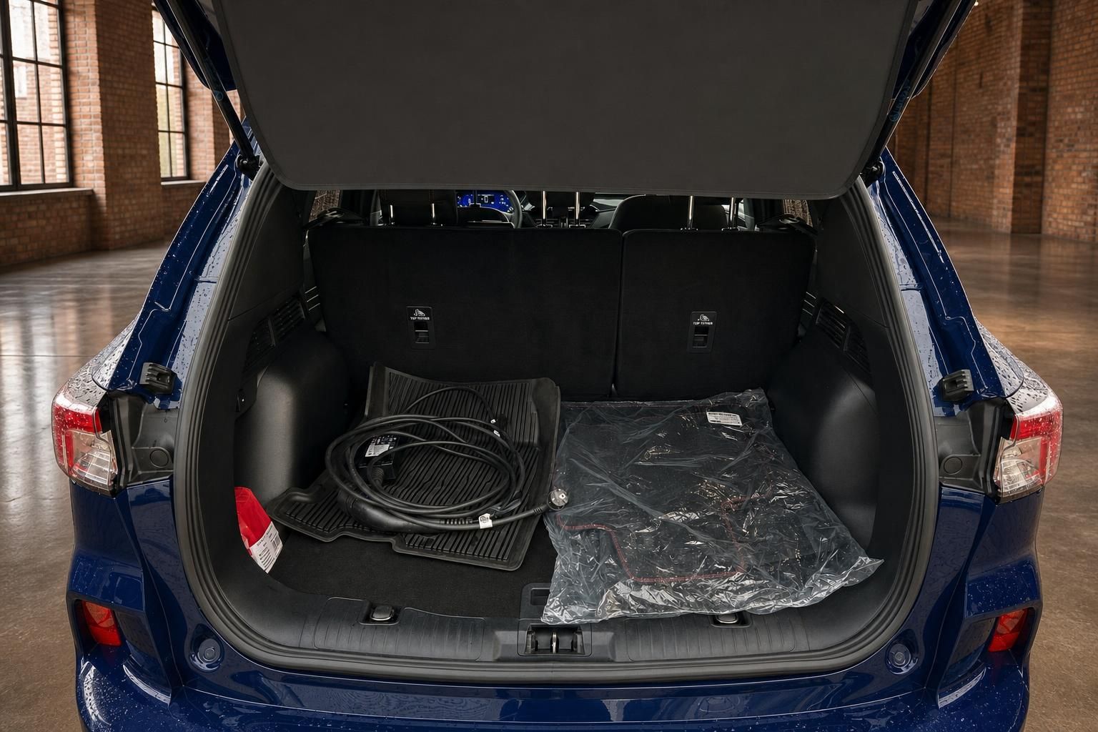 Ford Kuga Kofferraum mit Ladekabel und Bodenmatten im Gepaeckraum