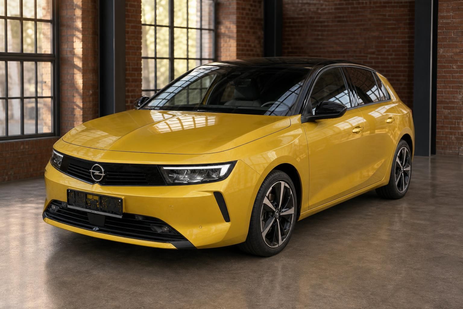 Opel Astra in Gelb, Seitenansicht schräg vorne in historischer Halle