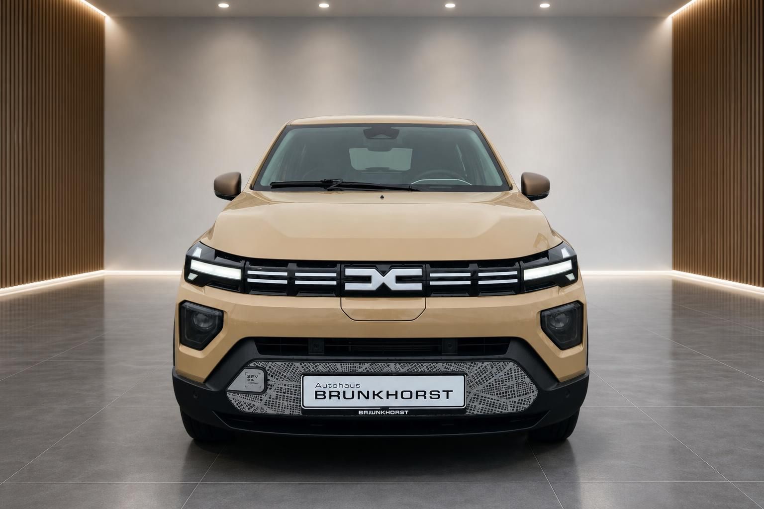 Dacia Spring Elektroauto Frontansicht in Goldbeige - kompakter Elektro-SUV von vorne