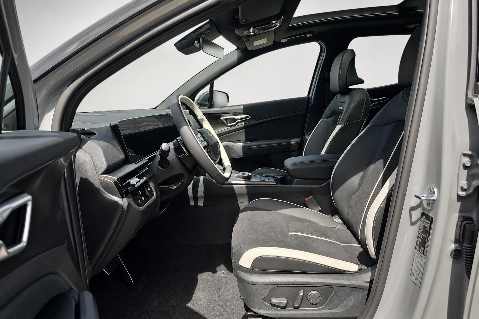 Innenraum Kia SUV mit Sportsitzen in Schwarz-Weiss und Lenkrad