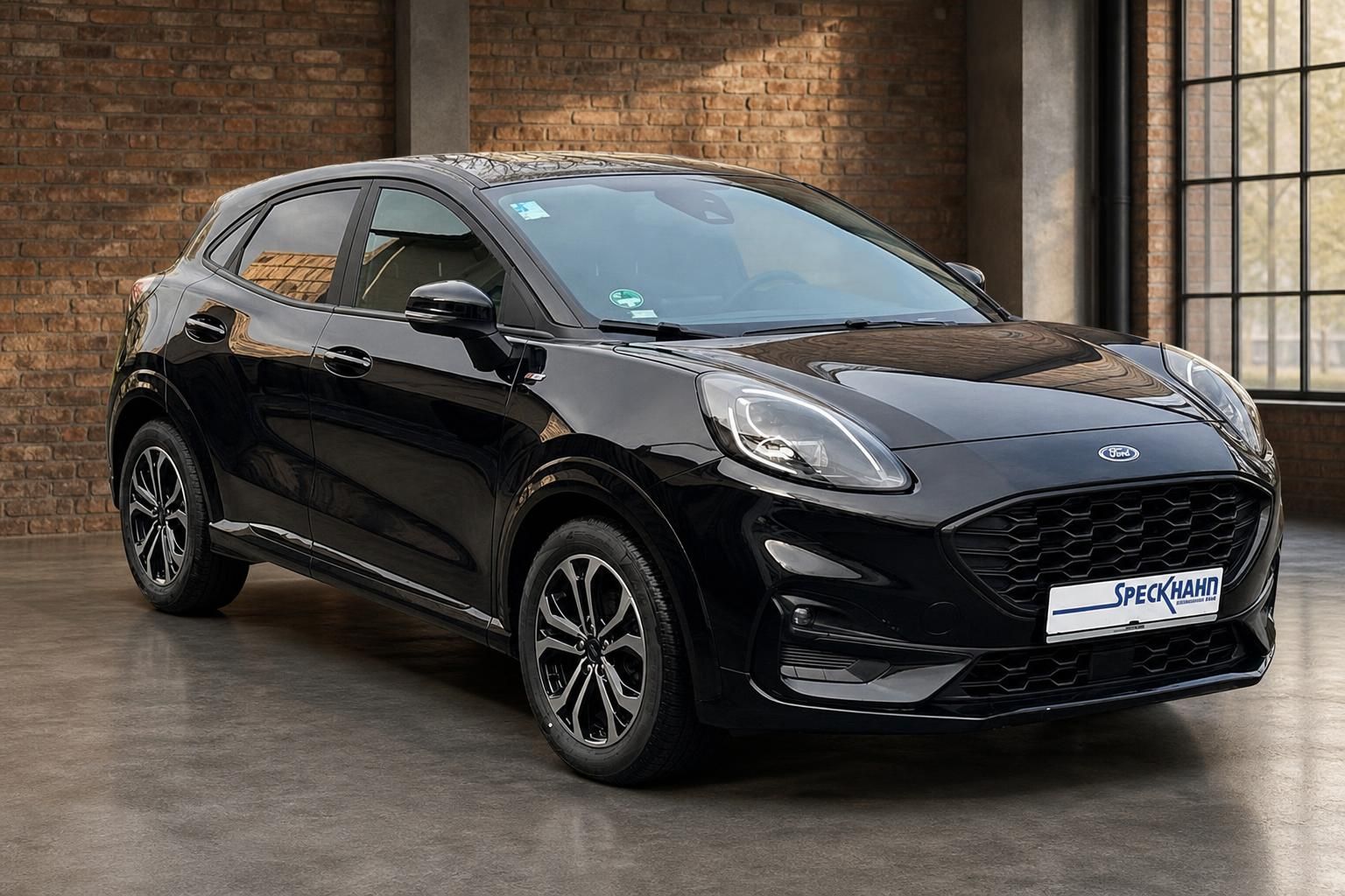 Ford Puma schwarz Frontansicht mit LED-Scheinwerfern in Backsteinhalle
