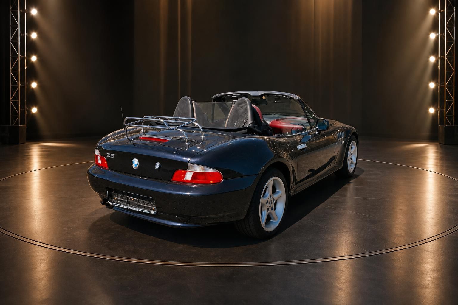 BMW Z3 Cabrio dunkelblau schräge Heckansicht im Ausstellungsraum mit dramatischer Beleuchtung