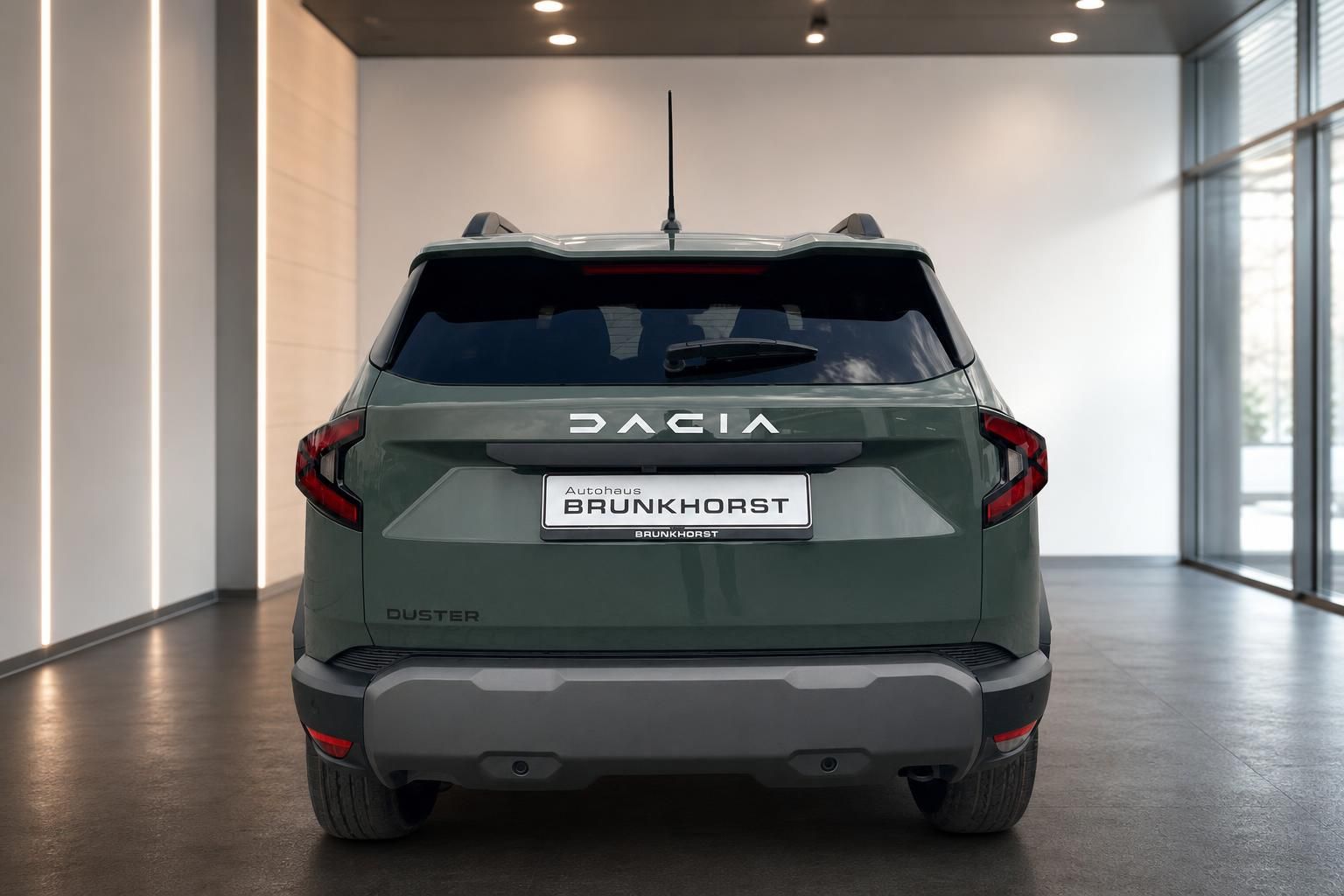 Dacia Duster SUV Heckansicht grün metallic mit Rücklichtern und Kennzeichenhalter im Showroom