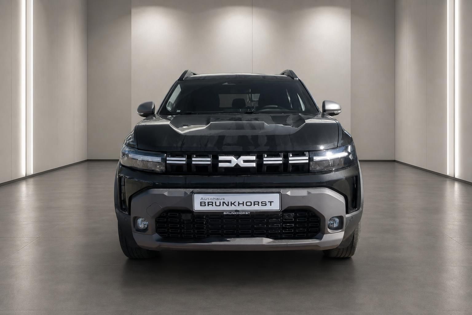 Dacia SUV Frontansicht in anthrazit mit charakteristischem Kühlergrill und LED-Tagfahrlicht