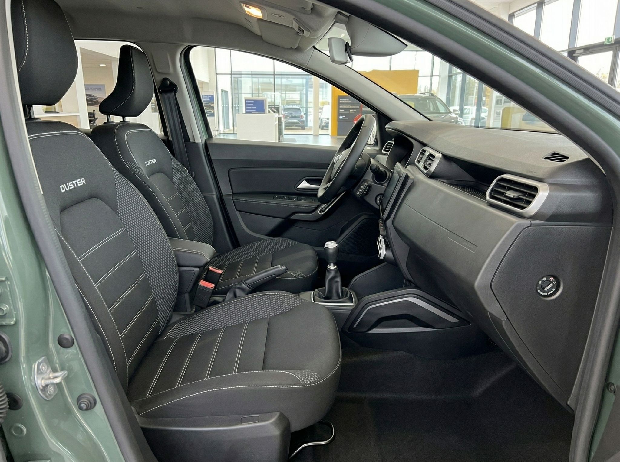 Dacia Duster Innenraum Beifahrerseite mit schwarzen Sportsitzen und DUSTER-Stickerei
