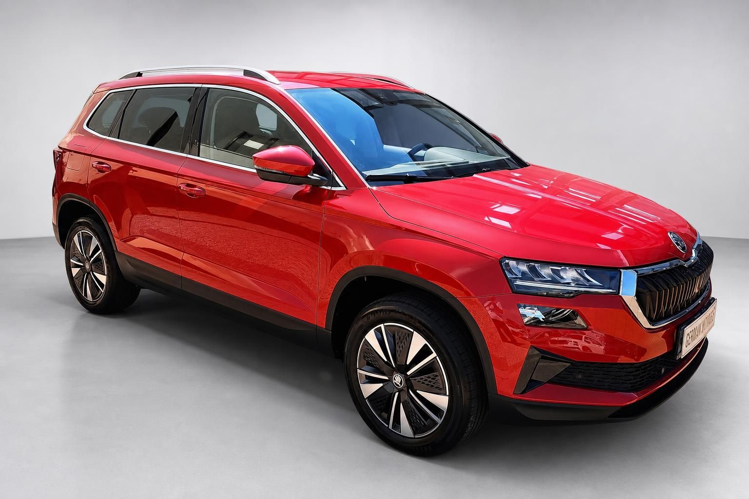 Roter Skoda Karoq SUV Frontansicht schraeg im Studio