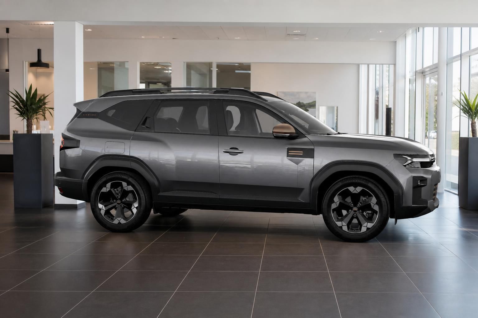 Dacia Bigster grau metallic Seitenansicht im Ausstellungsraum
