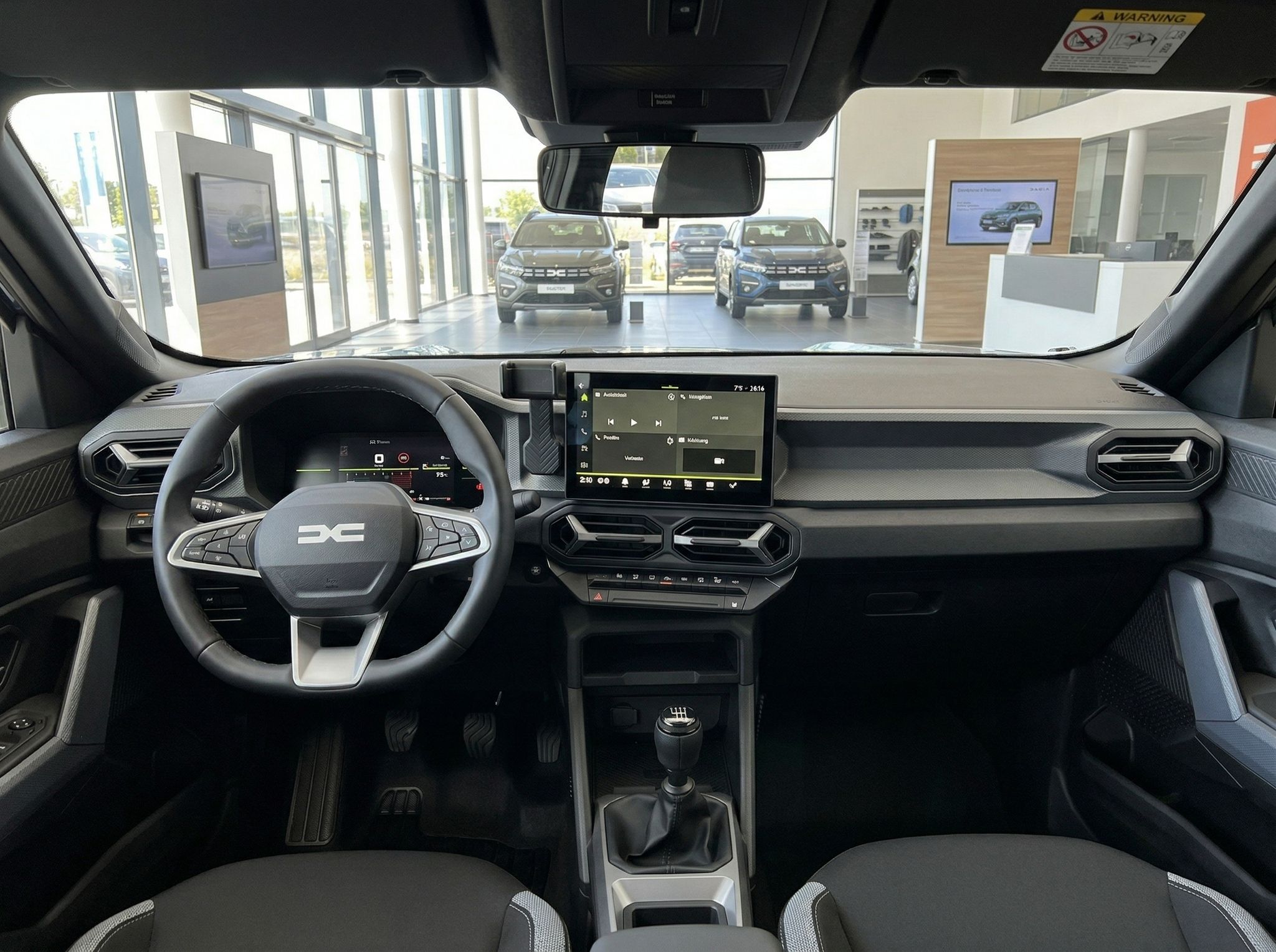 Fahrzeuginnenraum mit Armaturenbrett, Lenkrad und Touchscreen-Display im modernen Design