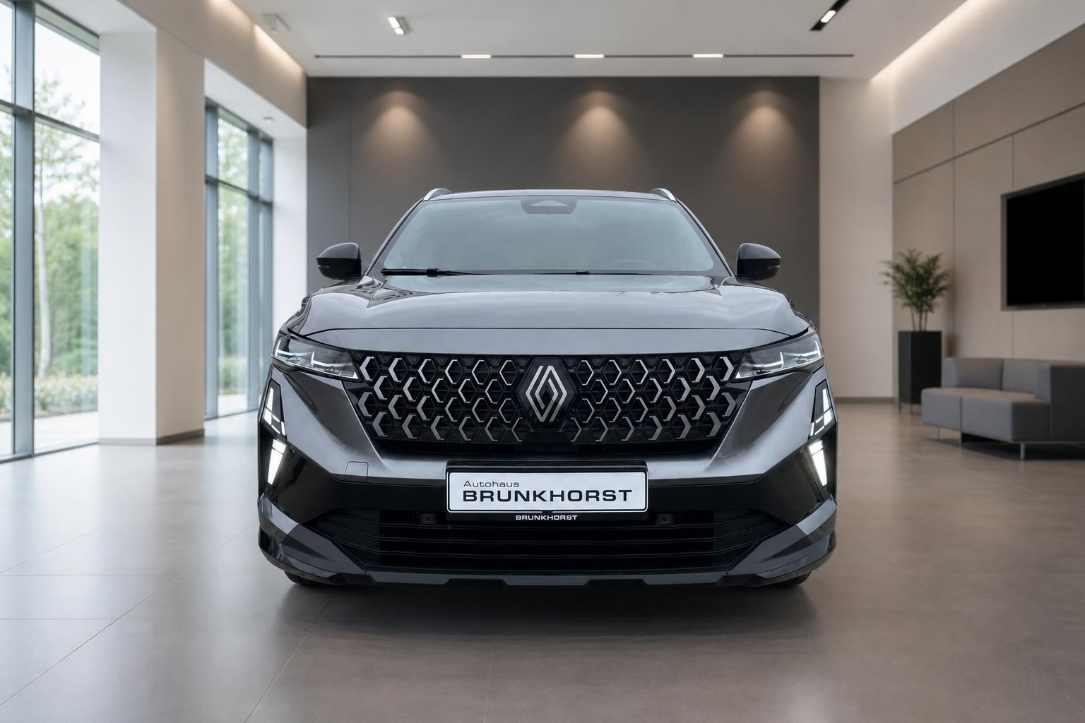 Renault Austral SUV grau Frontansicht mit Kühlergrill und LED-Scheinwerfern im Showroom