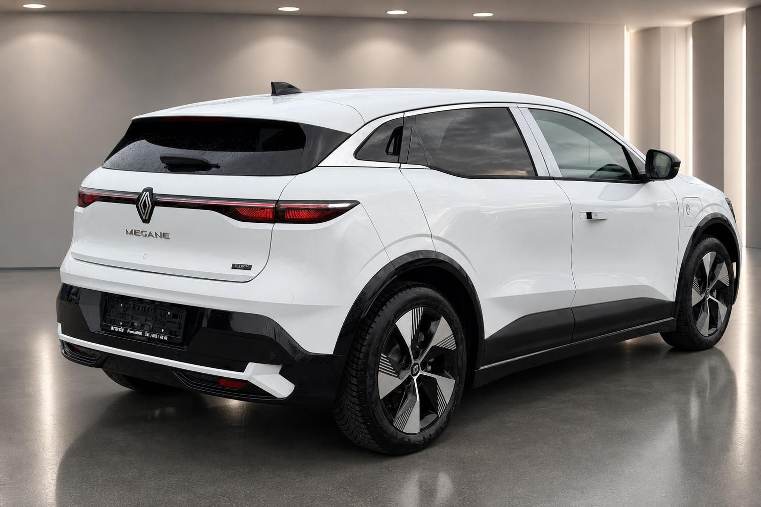 Renault Megane E-Tech weiß, Heckansicht seitlich im Showroom