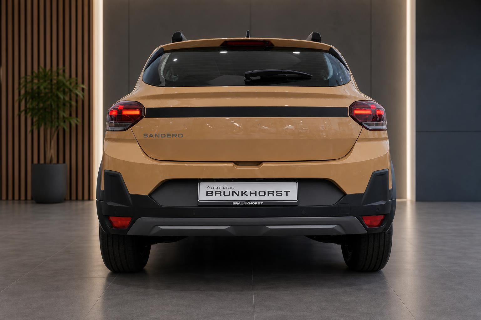 Dacia Sandero Stepway in Beige, Heckansicht in der Autohaus-Ausstellung