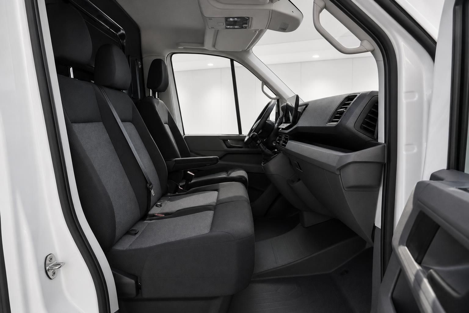 Innenraum Beifahrersitze eines weißen VW Transporters mit Blick auf Armaturenbrett