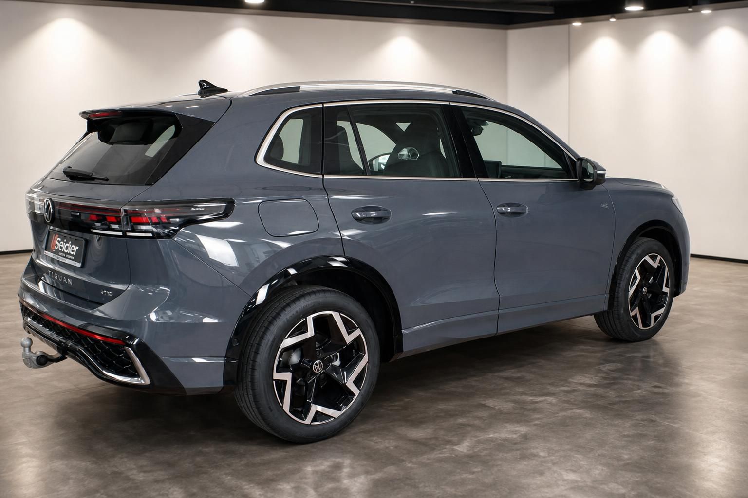 VW Tiguan grau Seitenansicht mit Anhängerkupplung im Autohaus