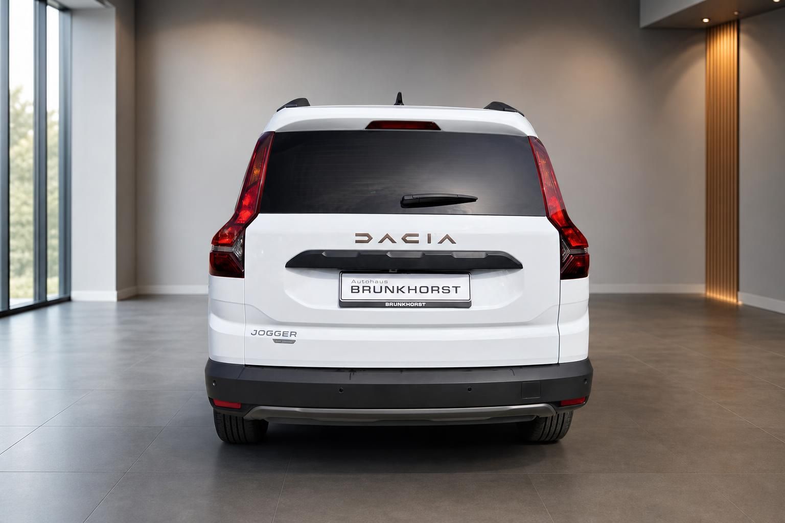 Dacia Jogger Heckansicht weiß mit roten Rückleuchten und DACIA Schriftzug im Autohaus