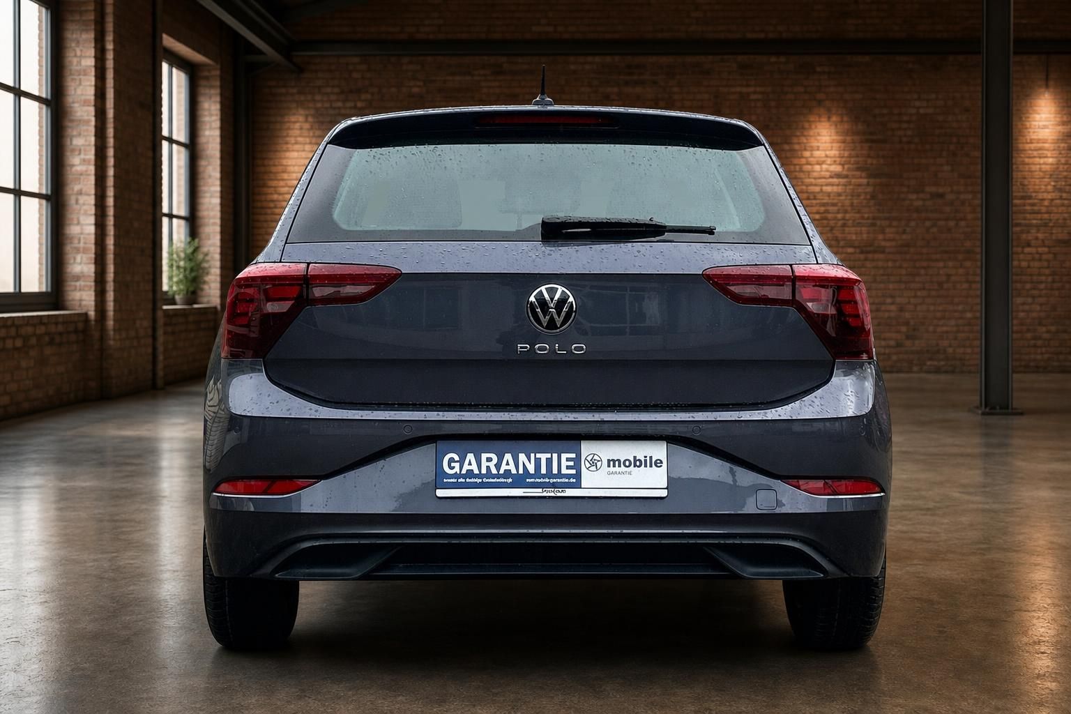 VW Polo grau Heckansicht in Industriehalle mit Kennzeichenhalter