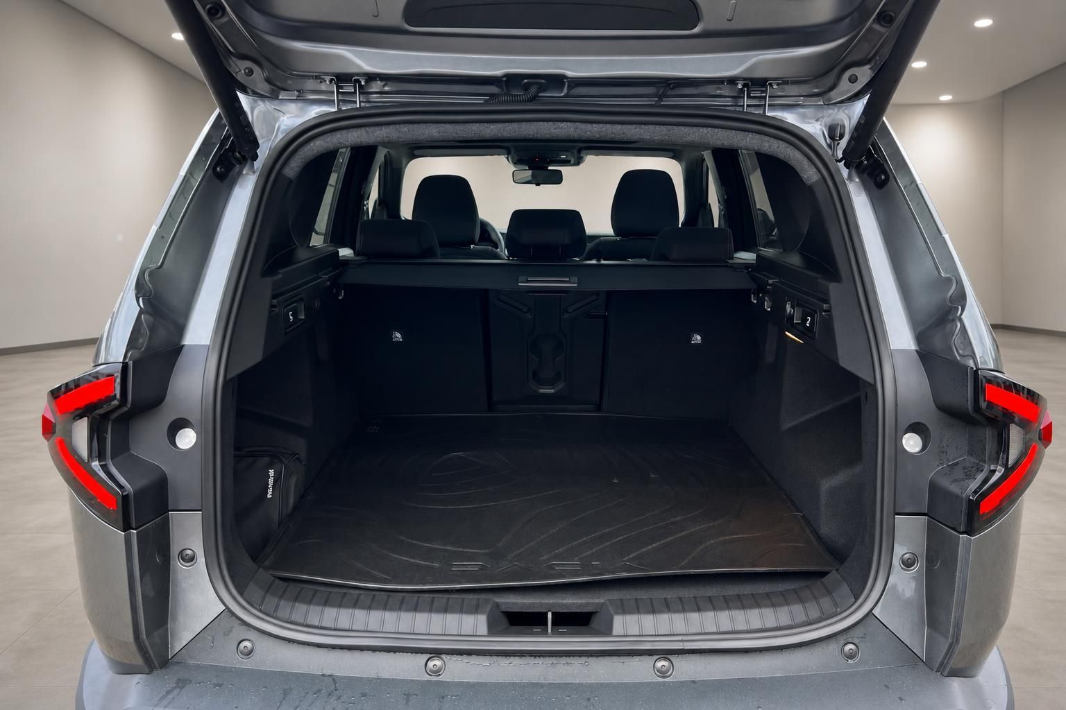 Kofferraum eines silbernen SUVs mit geöffneter Heckklappe und schwarzer Innenausstattung im Autohaus