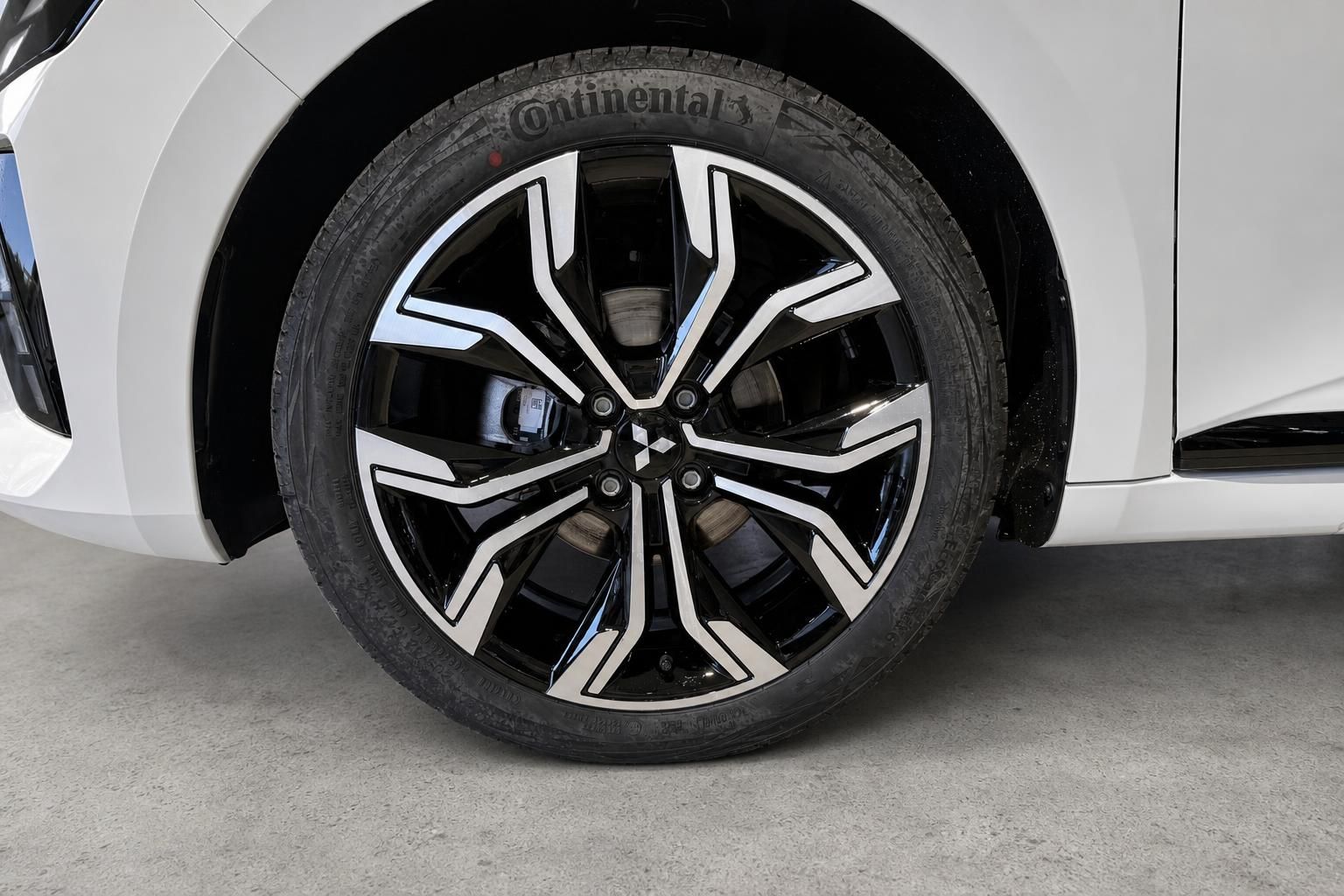 Detailansicht des schwarz-silbernen Leichtmetallfelgen am Mitsubishi Colt