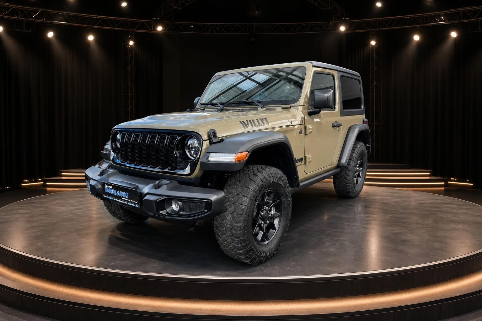 Jeep Wrangler Willys in beige, Dreiviertel-Frontansicht mit Geländereifen im Showroom