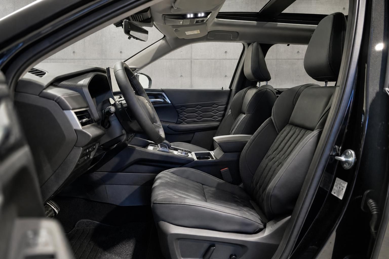 Vordersitze und Cockpit im Innenraum eines schwarzen Mitsubishi SUV