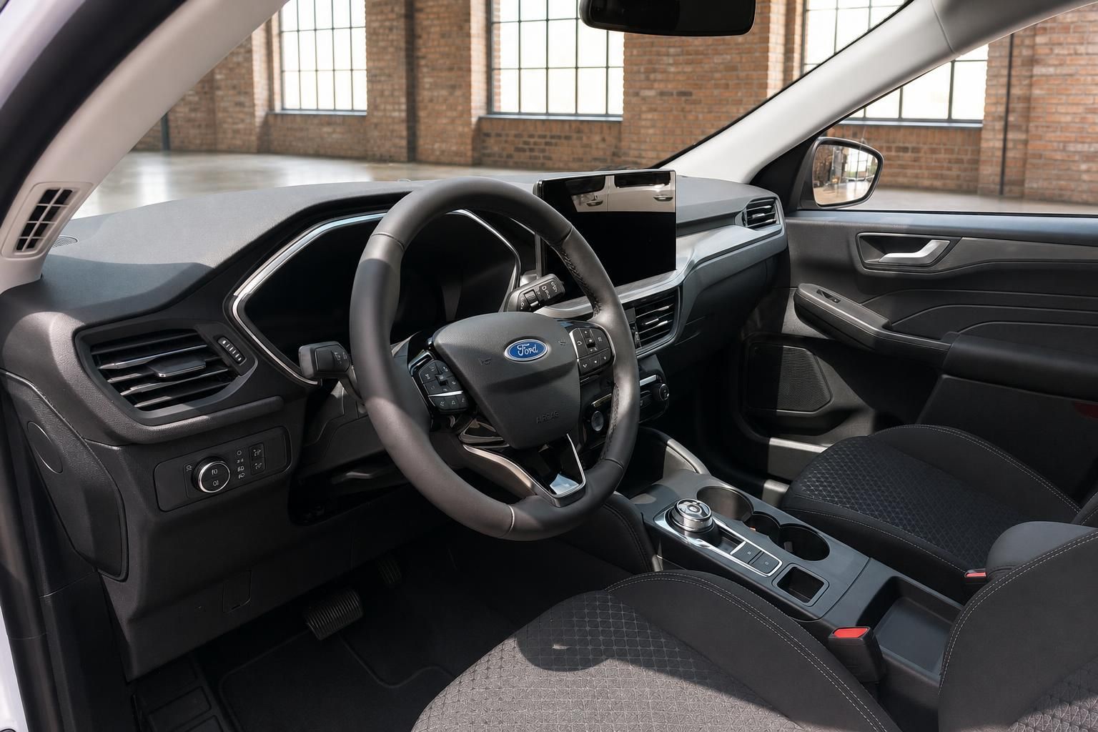 Ford Kuga Innenraum Cockpit mit Lenkrad Mittelkonsole und schwarzen Stoftsitzen Fahrerseite