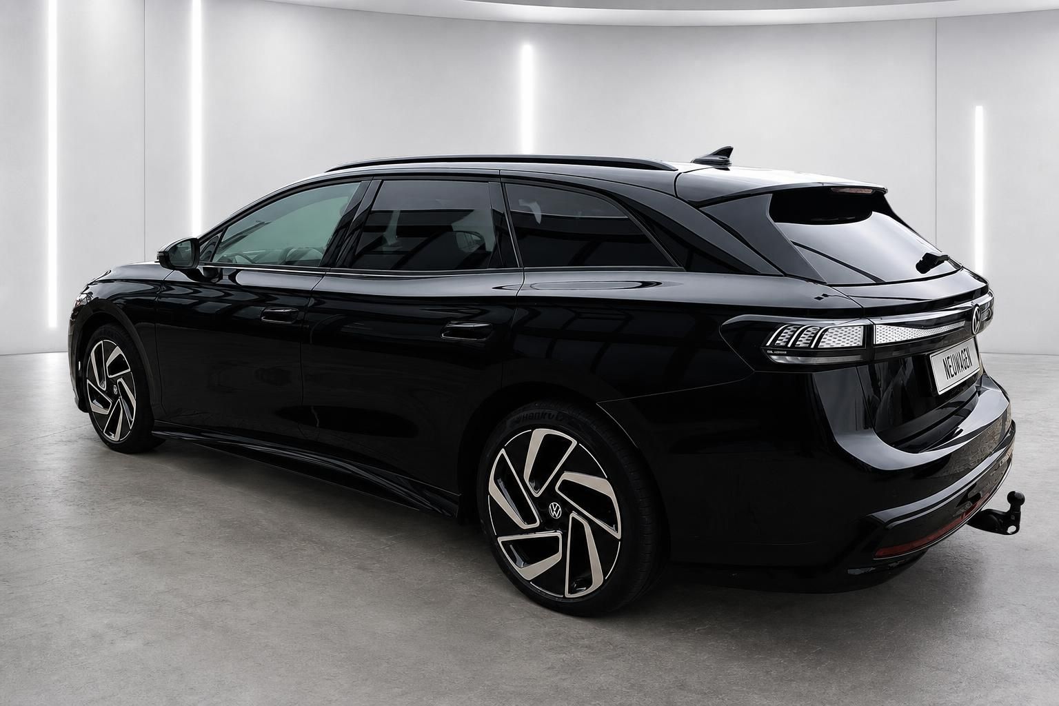 VW ID.7 Tourer schwarz Heckansicht schraeg mit Anhaengerkupplung
