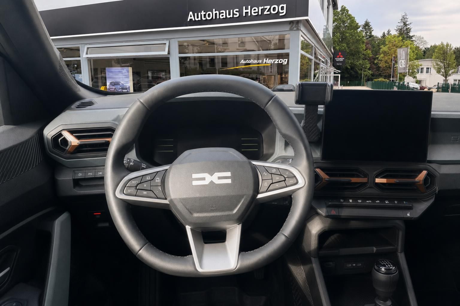 Dacia Duster Cockpit mit Lenkrad, Tacho und Mittelkonsole - Blick vom Fahrersitz
