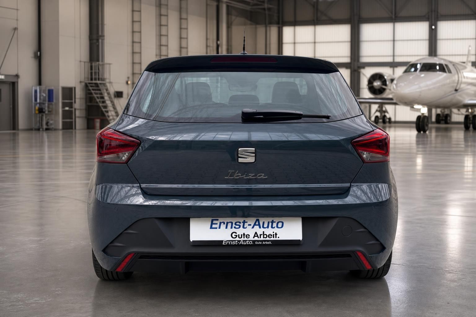 Seat Ibiza Heckansicht in grau-blau mit Ernst-Auto Kennzeichen in Hangar