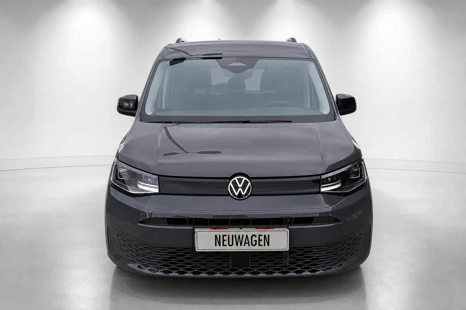 VW Caddy grau Frontansicht mit Neuwagen Kennzeichen