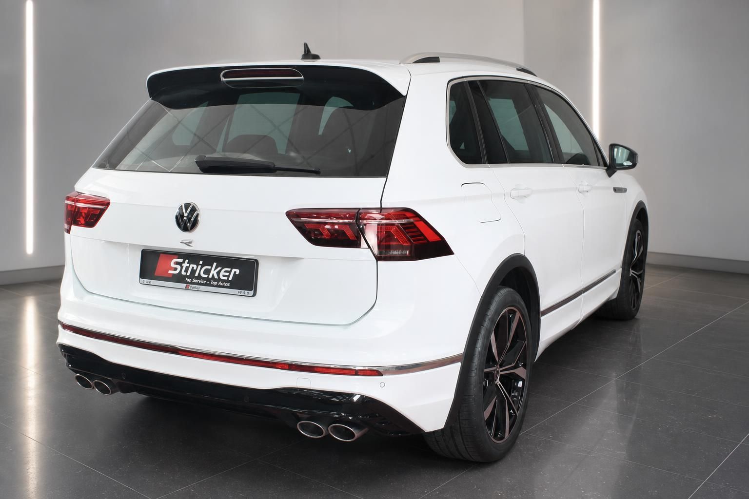 VW Tiguan R-Line weiss Heckansicht schraeg links mit LED-Rueckleuchten und Quad-Auspuff