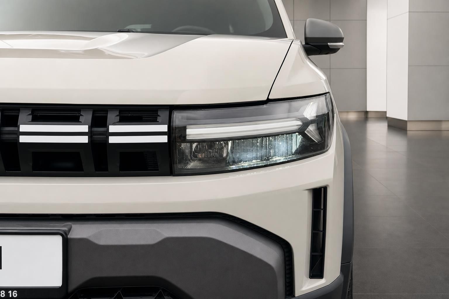 Dacia Duster Frontdetail mit LED-Scheinwerfer und Kuehlergrill in Weiss