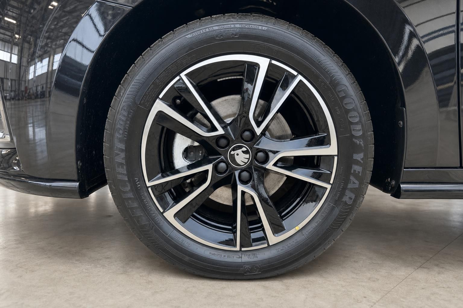 Skoda Leichtmetallfelge mit schwarz-silbernem Design an schwarzem Fahrzeug