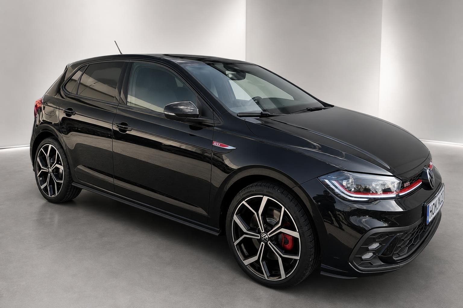 VW Polo GTI schwarz Frontansicht mit LED-Scheinwerfern und roter Kuehlerspange